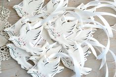 some white ornaments are laying on a table