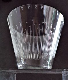 a clear glass bowl sitting on top of a shelf