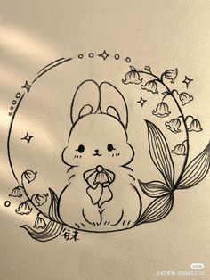 an ink drawing of a bunny with flowers around it