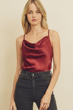 Satin cami bodysuit featuring a cowl neck and bottom line with snap button closure. Adjustable shoulder straps. Color: Burgundy. 100% Polyester. Model Info:Height: 5 ft 9 in | Bust: 32 in | Waist: 25 in | Wearing Size S. Runs true to size. Holiday Party Tops, Cowl Neck Cami, Satin Camisole, Cami Bodysuit, Tank Bodysuit, Satin Cami, Joy To The World, Girls Night Out, Beautiful Fashion