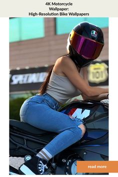 a woman sitting on the back of a motorcycle wearing a helmet and blue jean pants