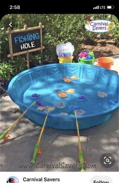 an inflatable swimming pool with fish on the bottom and sticks sticking out of it