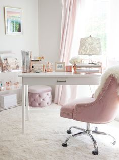 a pink chair sitting in front of a white desk