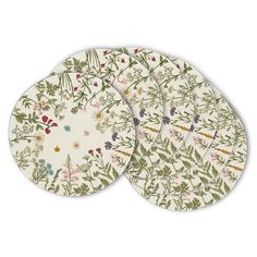 three coasters with floral designs on them