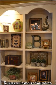 an open bookcase with pictures and other items on it