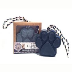 a dog's paw soap in a box next to a rope