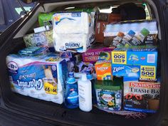 the trunk of a car filled with food and drinks, including milk, eggs, yogurt, water, and other items