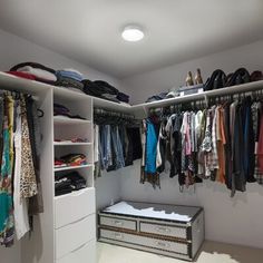 the closet is full of clothes and shoes