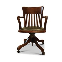 an old fashioned wooden desk chair with leather seat and casteor wheels, on a white background