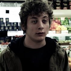 a young man in a grocery store looking at the camera