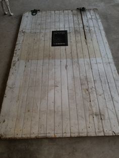 a dog standing next to a wooden floor with a plaque on it's side