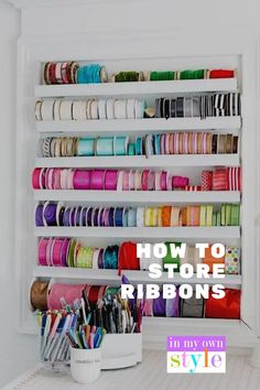 a white shelf filled with lots of different colored ribbons