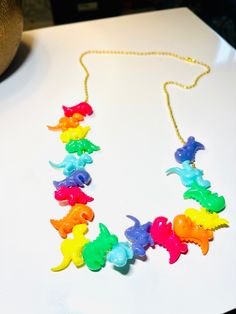 "The perfect Whimsical necklace for the perfect Dino lover! Available on a gold tone or silver tone necklace. Silver is 18\", gold in 16\", 18\", 20\", 22\".  While the materials are simple, it does take time to make. Price includes time to make." Dino Necklace, Printable Paper Patterns, Teacher Jewelry, Whimsical Necklace, Dinosaur Necklace, Lover Jewelry, Spring Bracelet, Whimsical Jewelry, Cute Patches