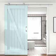 an open door leading to a bathroom with a toilet and shower in the background on a wooden floor