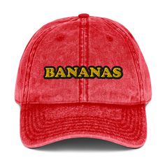 A vintage style, cotton, embroidered bananas dad hat. Go bananas and make a statement in this eye-catching, conversation starting dad hat. It comes in a variety of colors with "bananas" in yellow and black embroidery. It's comfortable, unique and made just for you. Wear this funky banana lover hat as everyday streetwear or give it as a funny gift for banana enthusiasts and foodies of all kinds. • 100% cotton twill• 6-panel unstructured cap• 6 sewn eyelets• Black sweatband• Metal snap buckle with Everyday Streetwear, Go Bananas, Black Embroidery, Detail Shop, Yellow And Black, Grey Khakis, Dad Hat, Bananas, Charcoal Grey