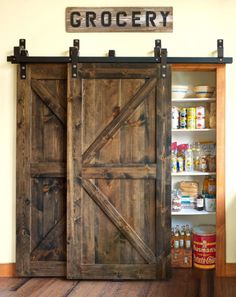 an open barn door with the word grocery written on it in front of a pantry