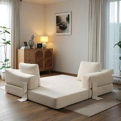 a living room with white furniture and wooden floors