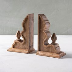 two wooden bookends sitting on top of a white table