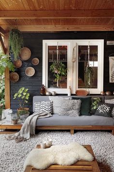 a living room filled with furniture and plants