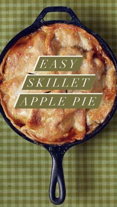 an easy skillet apple pie in a cast iron skillet on a green checkered tablecloth