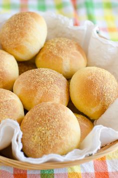 a basket filled with rolls sitting on top of a table