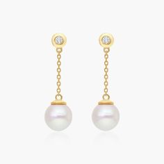 The simplicity of these drop earrings featuring 8.0-8.5mm akoya pearls is all the more luxurious with the added touch of a bezel set diamond. An excellent present for anyone who appreciates simple glamour. Luxury Yellow Gold Drop Pearl Earrings, Yellow Gold Briolette Pearl Earrings For Formal Occasions, Timeless Akoya Pearl Drop Earrings, Yellow Gold Dangle Earrings With Akoya Pearl, Yellow Gold Briolette Pearl Earrings, Classic Yellow Gold Briolette Pearl Earrings, Elegant Yellow Gold Briolette Pearl Earrings, Classic Briolette Yellow Gold Pearl Earrings, Anniversary Akoya Pearl Earrings With Pearl Chain