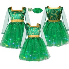 two children's green dresses with gold trims and sequins on them