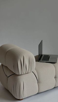 a couch with a laptop on top of it