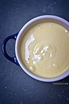 a blue and white cup filled with liquid