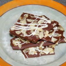 three pieces of chocolate with white toppings on a plate