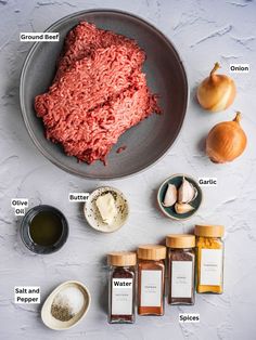 ingredients for ground beef in a bowl on a table with garlic, garlic and seasonings