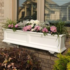 a white window box with flowers in it