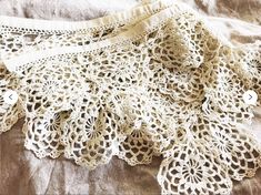 an old lace doily is laying on a bed sheet that has been made into a skirt