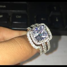 a woman's hand with a diamond ring on it