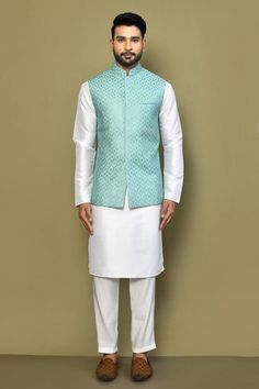 Blue sleeveless bundi with all over sequin fleur jaal embroideries. Paired with a white full sleeves plain kurta and a pant. - Aza Fashions Fitted Nehru Jacket With Zari Work For Spring, Fitted Festive Vest With Zari Work, Festive Fitted Vest With Zari Work, Fitted Nehru Jacket Straight Kurta For Spring, Fitted Sleeveless Outerwear For Festive Occasions, Sleeveless Fitted Kurta With Pallu, Fitted Sleeveless Nehru Jacket With Zari Work, Fitted Bollywood Style Sleeveless Nehru Jacket, Fitted Sleeveless Nehru Jacket With Resham Embroidery