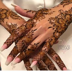 two hands with henna designs on them