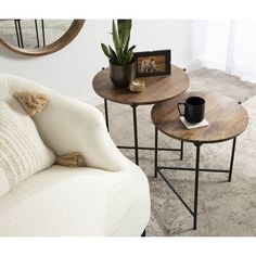 two small tables sitting next to each other in a living room