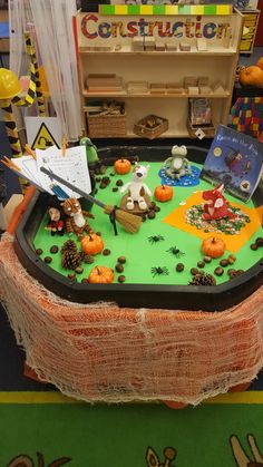 a table topped with lots of fake toys and decorations on top of a green surface