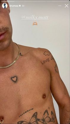 a shirtless man with tattoos on his chest