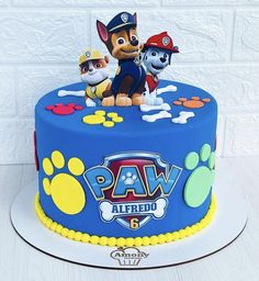 a birthday cake decorated with paw patrol characters