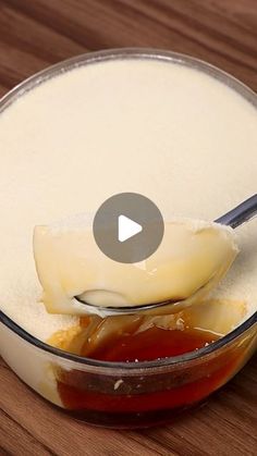 a spoon full of cheese and sauce in a bowl