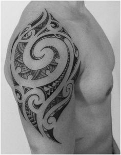 a black and white photo of a man's arm with an intricate tattoo design on it