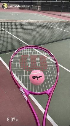 a tennis racket with a pink ball on it and the words wilson painted on it