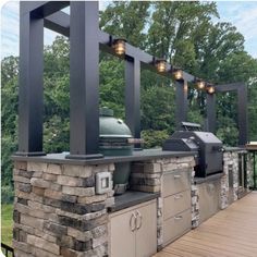 an outdoor bbq with grills and lights on it