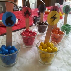 the table is set up with candy and candies in small bowls on top of each other