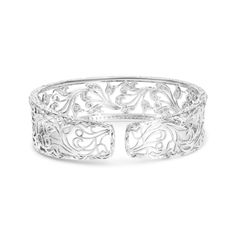 This resplendent openwork bangle cuff is a showpiece with 164 round white diamonds in an elegance-enhancing pave setting. A magnificent openwork floral filigree swirl design makes this piece of jewelry stunning, and it radiates a luminous sparkle with 3 1/4 total cttw diamonds of an approximate H-I color and VS2-SI1 clarity. Lustrous 18k white gold enhances the luxury and allure of this open cuff bracelet and brings a defining style that will not soon be forgotten. This bangle is approx 7 inches Filigree Bangle, Floral Filigree, Filigree Bracelet, Open Cuff Bracelet, Summer Clearance, Filigree Design, Pave Setting, Swirl Design, Bracelet Collection