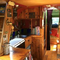 the inside of a tiny house with wooden floors and walls, including a kitchen area