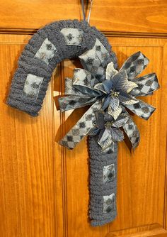 a door hanger made out of fabric with a checkered bow hanging from it