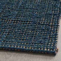 a close up view of a blue rug with brown and tan dots on the bottom