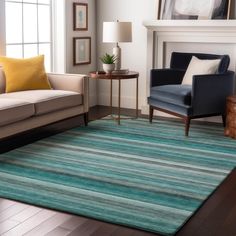 a living room filled with furniture and a rug on top of a hard wood floor